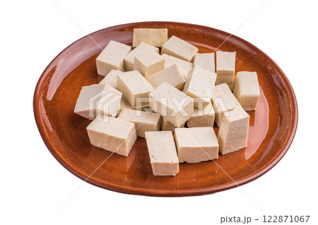 Uncooked Diced soybean tofu cheese on plate isolated on white background. top view 122871067