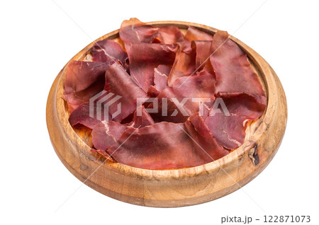 Cecina meat slices, spanish beef jamon on wooden tray isolated on white background. top view Cecina meat slices, spanish beef jamon on wooden tray isolated on white background. top view 122871073