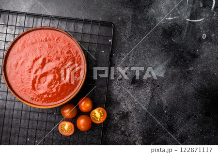 Canned Tomato sauce Passata, preserved paste for cookng. black background. top view 122871117