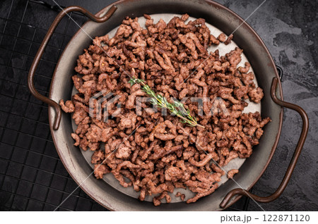 Fried mince beef and pork meat, fresh cooked mincemeat. black background. top view Fried mince beef and pork meat, fresh cooked mincemeat. black background. top view 122871120