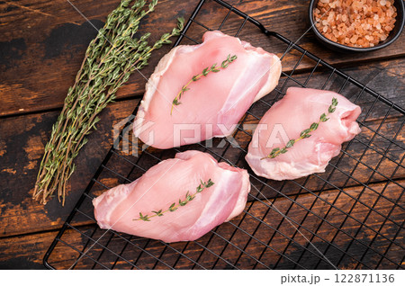 Raw Skinless boneless chicken thighs fillet. wooden background. top view 122871136