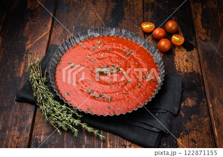 Tomato paste sauce with thyme in plate, canned food for cookng. wooden background. top view Tomato paste sauce with thyme in plate, canned food for cookng. wooden background. top view 122871155