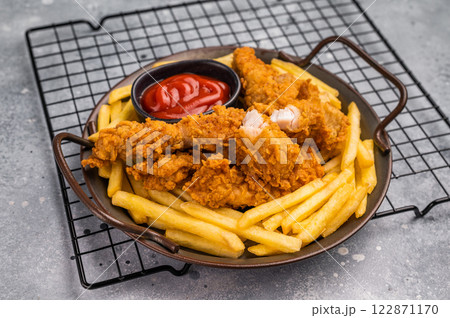 Deep fried chicken strips, stick from breast fillet. grey background. top view Deep fried chicken strips, stick from breast fillet. grey background. top view 122871170