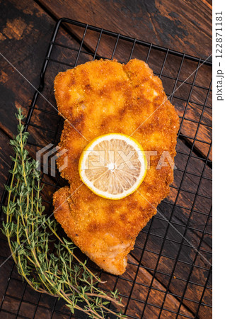 Fried Wiener chicken schnitzel steak, breaded meat. wooden background. top view 122871181