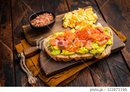 Sandwich with smoked salmon, trout, avocado and red caviar. wooden background. top view 122871198