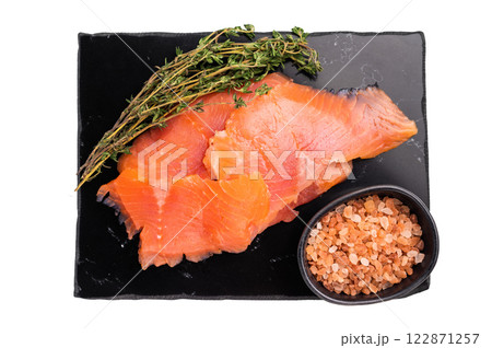 Salty salmon, trout fillet slices with herbs isolated on white background. top view Salty salmon, trout fillet slices with herbs isolated on white background. top view 122871257