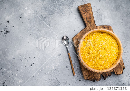 Millet flakes in wooden bowl, rolled millet for porridge and muesli. grey background. top view Millet flakes in wooden bowl, rolled millet for porridge and muesli. grey background. top view 122871328