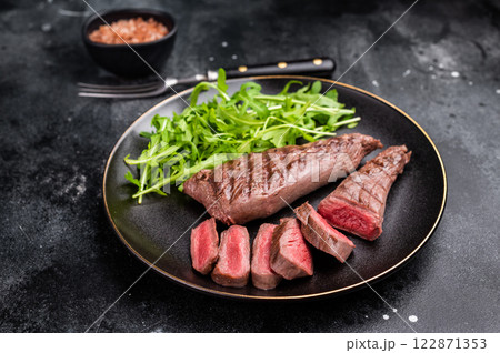Grill Lamb steak, roasted mutton tenderloin fillet meat with salad. black background. top view 122871353