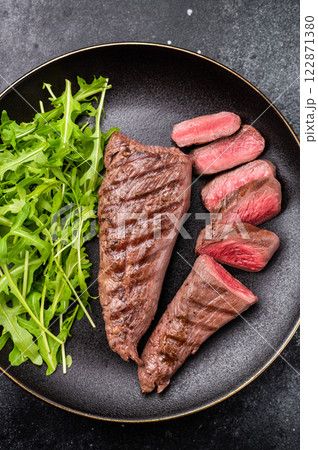 Grill Lamb steak, roasted mutton tenderloin fillet meat with salad. black background. top view 122871380
