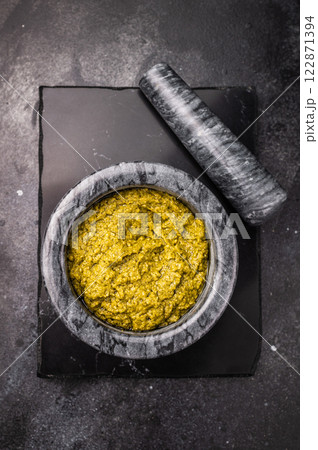 Iitalian spread sauce pesto with green basil in bowl. black background. top view 122871394