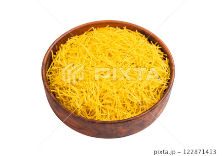 Raw uncooked vermicelli pasta in a bowl isolated on white background. top view Raw uncooked vermicelli pasta in a bowl isolated on white background. top view 122871413