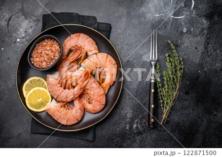 Uncooked Headless Red shrimps, raw Prawns on plate. black background. top view 122871500