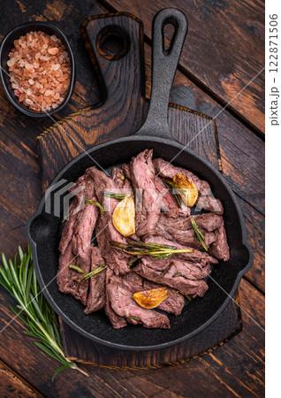 Grilled and sliced Beef top sirloin Steak in a pan. wooden background. top view 122871506