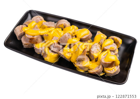 BBQ Grilled and sliced Sausages with cheese and mustard sauce in plate isolated on white background. top view BBQ Grilled and sliced Sausages with cheese and mustard sauce in plate isolated on white background. top view 122871553