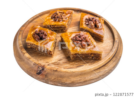 Arabic Traditional Honey Walnut Baklava on wooden board isolated on white background. top view 122871577