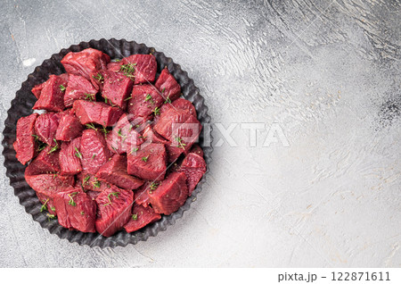 Ready for cooking Diced Raw kangaroo meat. white background. top view 122871611