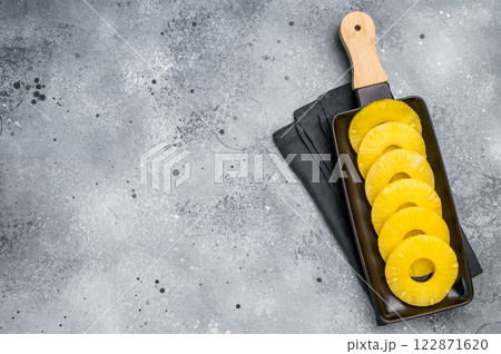 Canned Pineapple rings slices on a board. grey background. top view Canned Pineapple rings slices on a board. grey background. top view 122871620