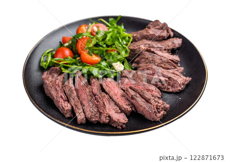 Grilled Beef Denver strip Steak on a plate with salad isolated on white background. top view 122871673