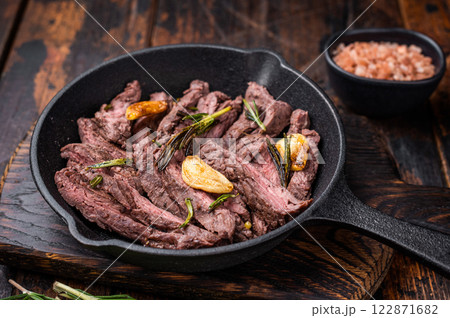 Grilled and sliced Beef top sirloin Steak in a pan. wooden background. top view Grilled and sliced Beef top sirloin Steak in a pan. wooden background. top view 122871682