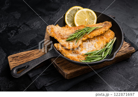 Pan Fried Hake white fish fillet. black background. top view Pan Fried Hake white fish fillet. black background. top view 122871697
