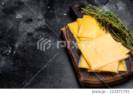 Fresh Processed Melted cheese, thin slices for toasts. black background. top view Fresh Processed Melted cheese, thin slices for toasts. black background. top view 122871791