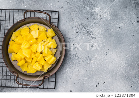 Canned Pineapple chunks slices in a bowl. grey background. top view 122871804