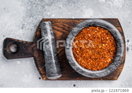 Cooking of Red Chili pepper and paprika flakes. grey background. top view Cooking of Red Chili pepper and paprika flakes. grey background. top view 122871869