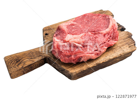 Raw Rib eye steak on wooden cutting board, dry aged prime beef meat isolated on white background Raw Rib eye steak on wooden cutting board, dry aged prime beef meat isolated on white background 122871977