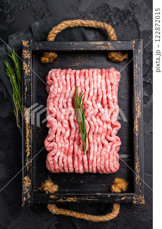 Fresh minced pork meat, raw mincemeat in wooden tray. black background. top view 122872015