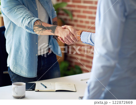 business people shaking hands in office meeting after successful partnership deal for startup company business people shaking hands in office meeting after successful partnership deal for startup company 122872669