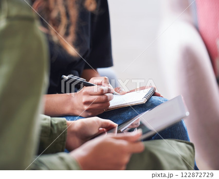 African american woman writing notes with friend showing ideas on digital tablet computer students brainstorming 122872729