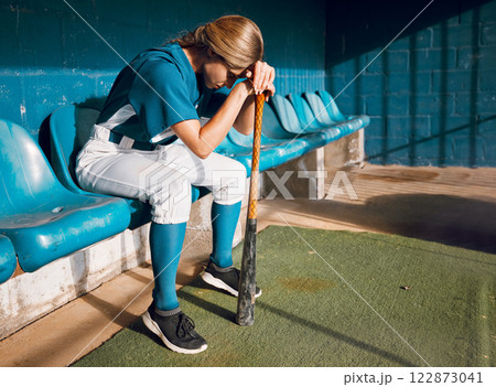 Baseball, sports bench and woman athlete angry thinking of game loss while waiting to play. Frustrated, sad and serious softball player girl in depressed mood for professional match failure. Baseball, sports bench and woman athlete angry thinking of game loss while waiting to play. Frustrated, sad and serious softball player girl in depressed mood for professional match failure. 122873041