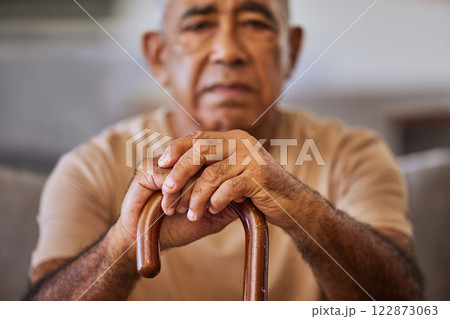 Portrait of sad senior man with a cane for walking support, assistance and help. Depression, mental health and hands of elderly man with walking stick depressed over retirement lifestyle or pension Portrait of sad senior man with a cane for walking support, assistance and help. Depression, mental health and hands of elderly man with walking stick depressed over retirement lifestyle or pension 122873063