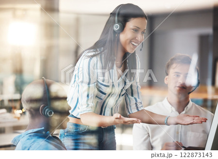 Call center, team manager training employees with computer in presentation meeting at a workplace office. Teamwork and leadership woman coaching telemarketing customer service agent with online talk 122873143