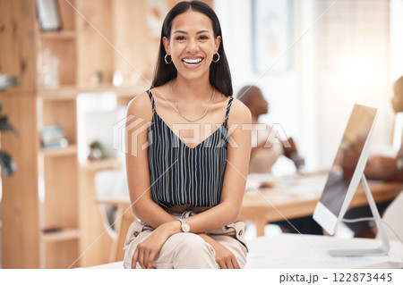 Smile, happy and business woman, desk portrait at work with blurred background. Leadership, motivation and smiling manager, leader or employee sitting with success, vision and confidence in office 122873445