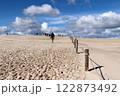 Beachgoers on the white sand dunes of Leba in the Slovincian National Park, Poland 122873492