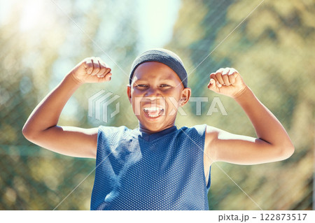 Children, sports and fitness with a strong boy flexing his biceps and having fun with sport outside. Kids, training and workout with a young male child outdoor for exercise, recreation or development 122873517