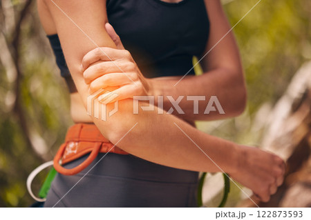 Woman, arm injury and pain while hiking, mountain climbing or fitness training outdoors in nature. Female sports athlete with medical joint inflammation from intense exercise in the countryside. 122873593