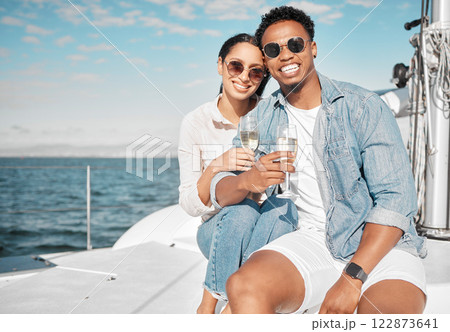 Happy couple on yacht with champagne smile and celebrate love with romantic tropical holiday travel on ocean. Dating man and woman on luxury boat on beach water or sea with wine glass for celebration Happy couple on yacht with champagne smile and celebrate love with romantic tropical holiday travel on ocean. Dating man and woman on luxury boat on beach water or sea with wine glass for celebration 122873641