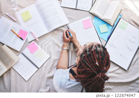Fashion, design and education with a woman student planning a creative project on a bed at home. Idea, drawing and notebook with a female artist drawing and writing for university or college homework 122874047