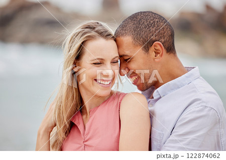 Love, happy and hug with couple together for romance, relationship and lifestyle on beach holiday trip. Happiness, care and support with man and woman in embrace on summer vacation date by the sea 122874062