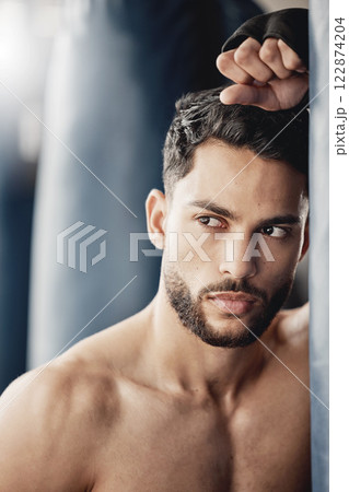 Fitness, exercise and boxing training by tough man boxer thinking and planning his strategy before a match. Young, athletic and handsome Mexican looking cool and serious, ready for physical challenge Fitness, exercise and boxing training by tough man boxer thinking and planning his strategy before a match. Young, athletic and handsome Mexican looking cool and serious, ready for physical challenge 122874204