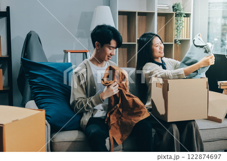 Smiling couple unpacking boxes in new house Smiling couple unpacking boxes in new house 122874697