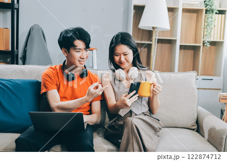 Smiling couple unpacking boxes in new house Smiling couple unpacking boxes in new house 122874712