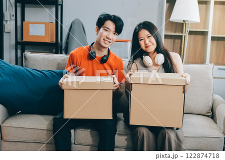 Smiling couple unpacking boxes in new house Smiling couple unpacking boxes in new house 122874718