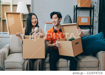 Smiling couple unpacking boxes in new house Smiling couple unpacking boxes in new house 122874719