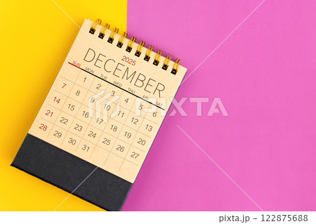 December 2025 desk calendar made from brown paper page on multicolor background. December 2025 desk calendar made from brown paper page on multicolor background. 122875688