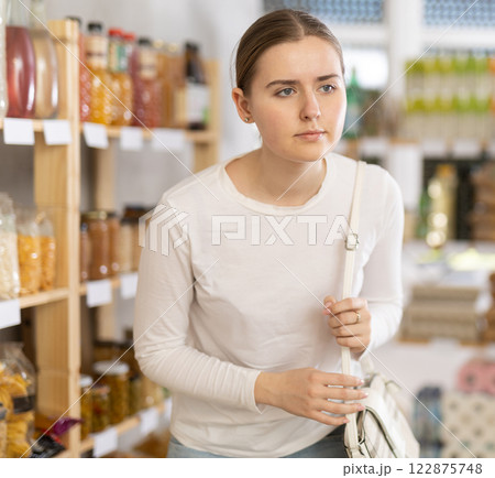 Young woman choosing food in grocery store 122875748