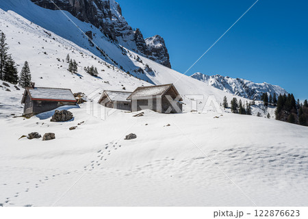 Wooden huts in the snow in the Swiss Alps, Switzerland 122876623