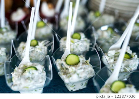 Snacks for the holiday, catering. Various snacks. Assortment of salads and buffet dishes. Meat, fish, cheese, salads, fruits and vegetables, sauces and canapes for celebrating a festive event. 122877030